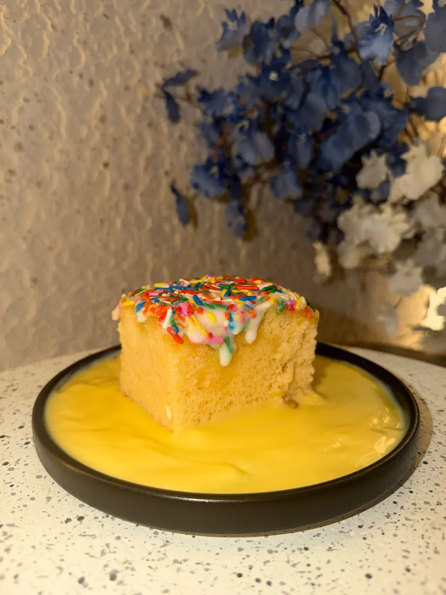 Sprinkle sponge with warm custard