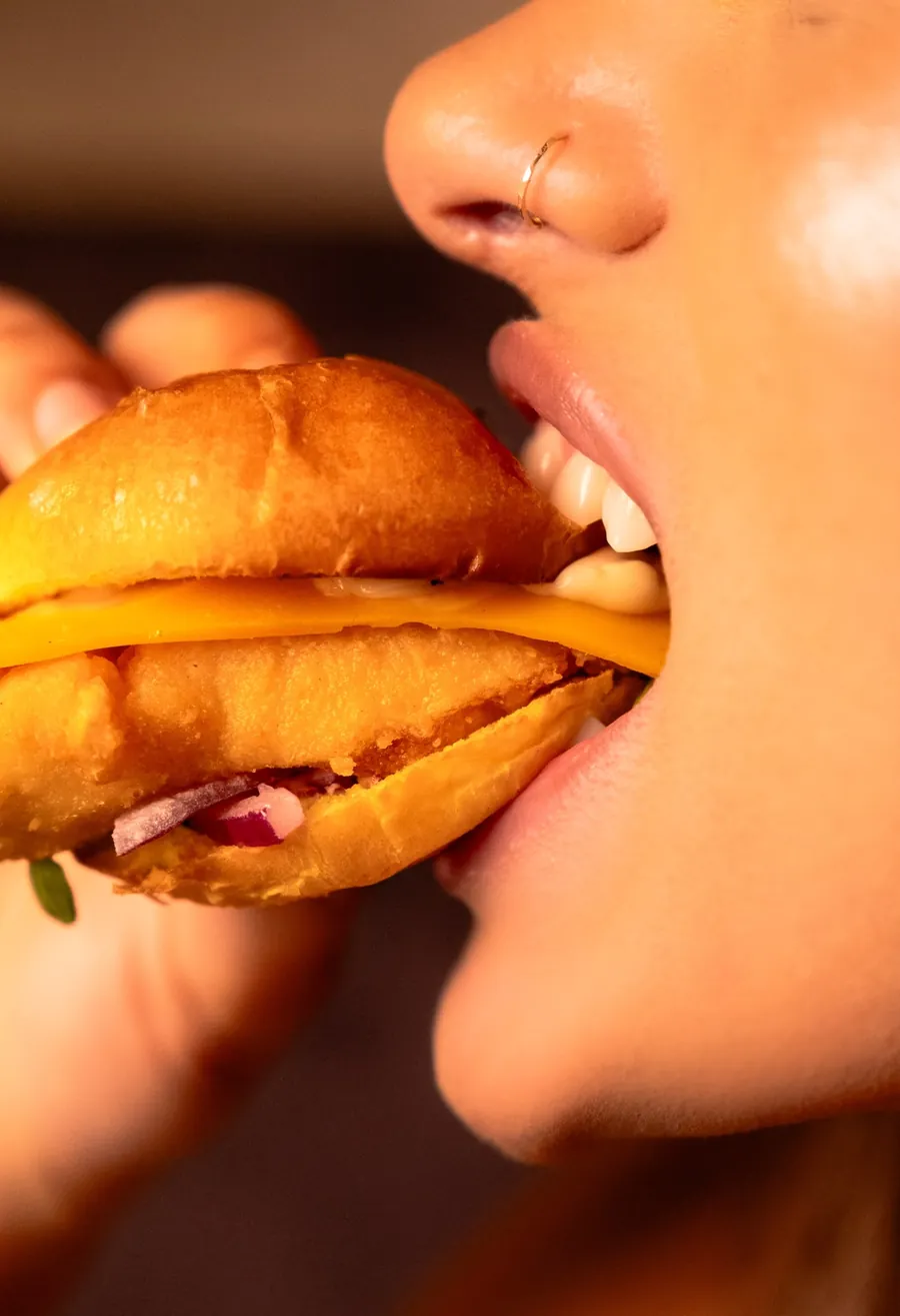 First bite of a crispy chicken burger