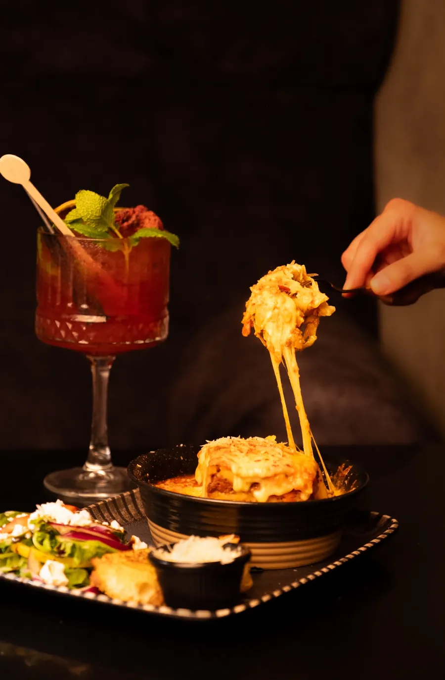 Cheese pull with a mocktail on the side