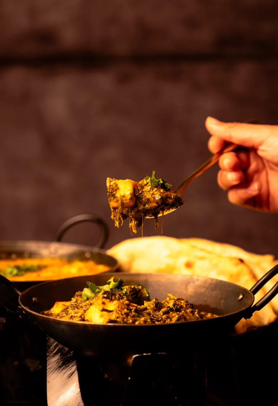 Scooping curry with naan