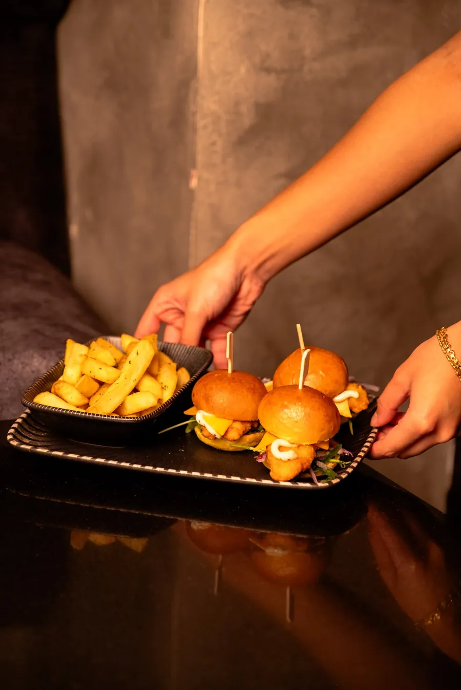 Sliders and fries being served