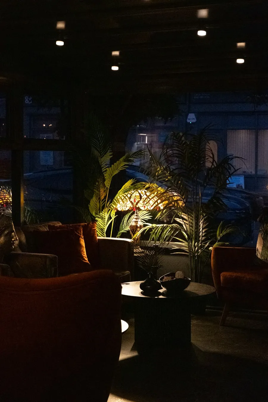 Velvet booth seating under warm lamps