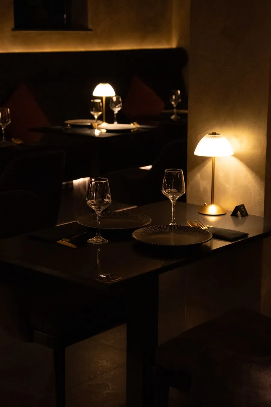 Dining tables set with brass lamps