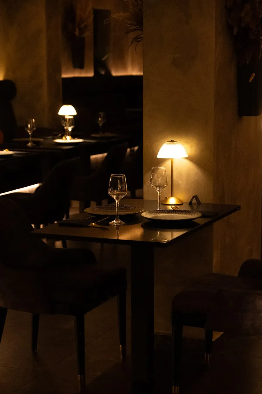A table for two set under a mushroom lamp